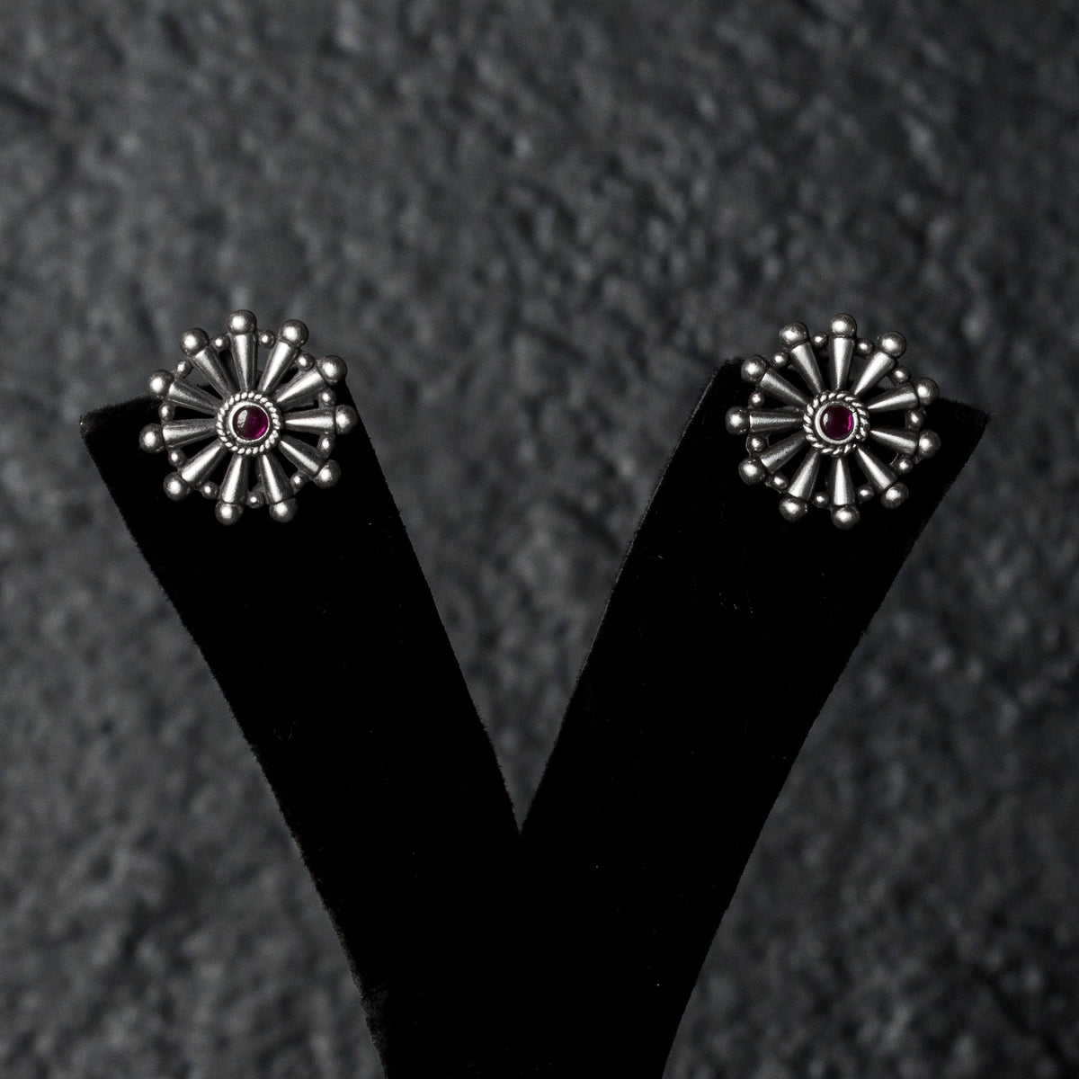 Chakrini Studs earrings with a small red centre stone.